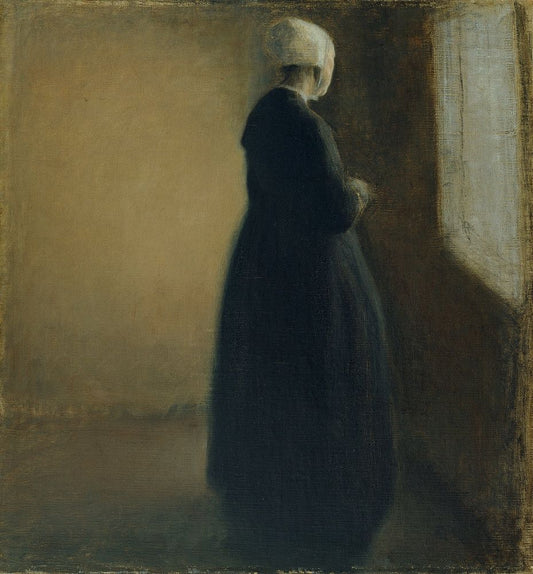 An old woman standing by a window - by Vilhelm Hammershøi